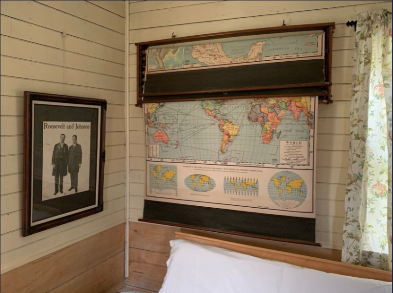 This VRBO still has the old maps and decor that you would expect to see in an old schoolhouse.