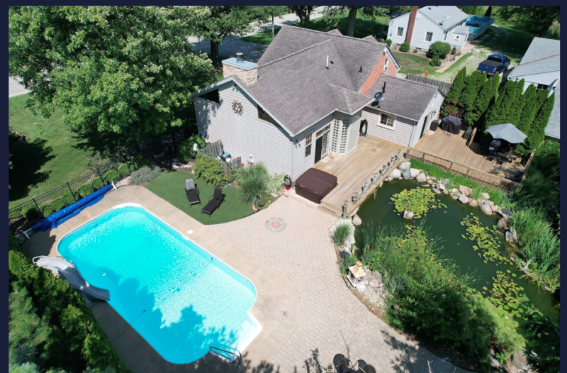 The backyard of this old schoolhouse is epic! A Pool, a koi pond, and a hot tub! 